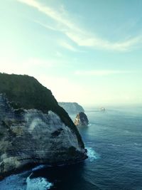 Rock formations in sea against sky