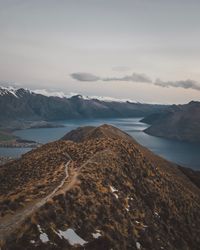 Scenic view of sea and mountains against sky