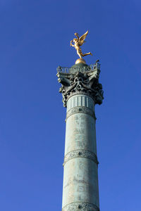 Low angle view of statue against clear blue sky