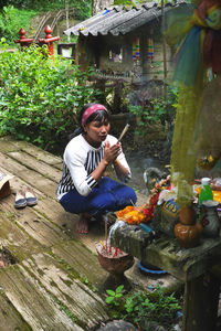 Full length of man sitting at temple