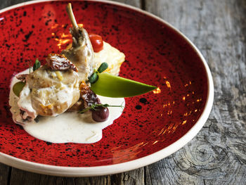 Stew rabbit with olives and dried tomatoes served in plate on table