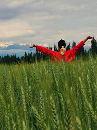 Person standing on field against sky