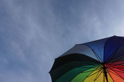 Low angle view of multi colored umbrella against sky