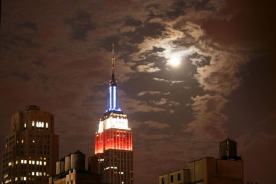 Low angle view of modern skyscraper against sky at night