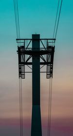 Low angle view of electricity pylon against sky