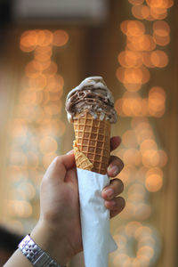 Close-up of hand holding ice cream cone