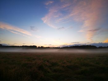 Scenic view of field against sky during sunset