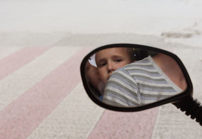 Portrait of boy with reflection in mirror