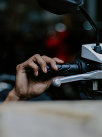 Cropped hand of man repairing motorcycle