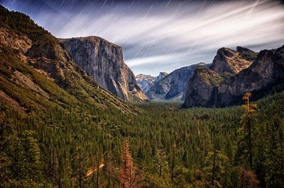 Scenic view of mountains against cloudy sky