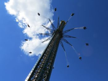 Low angle view of chain swing ride against blue sky