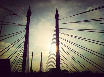 Low angle view of silhouette bridge against sky