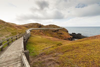 Scenic view of sea and mountains against sky