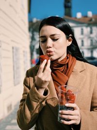 Young woman drinking glasses outdoors