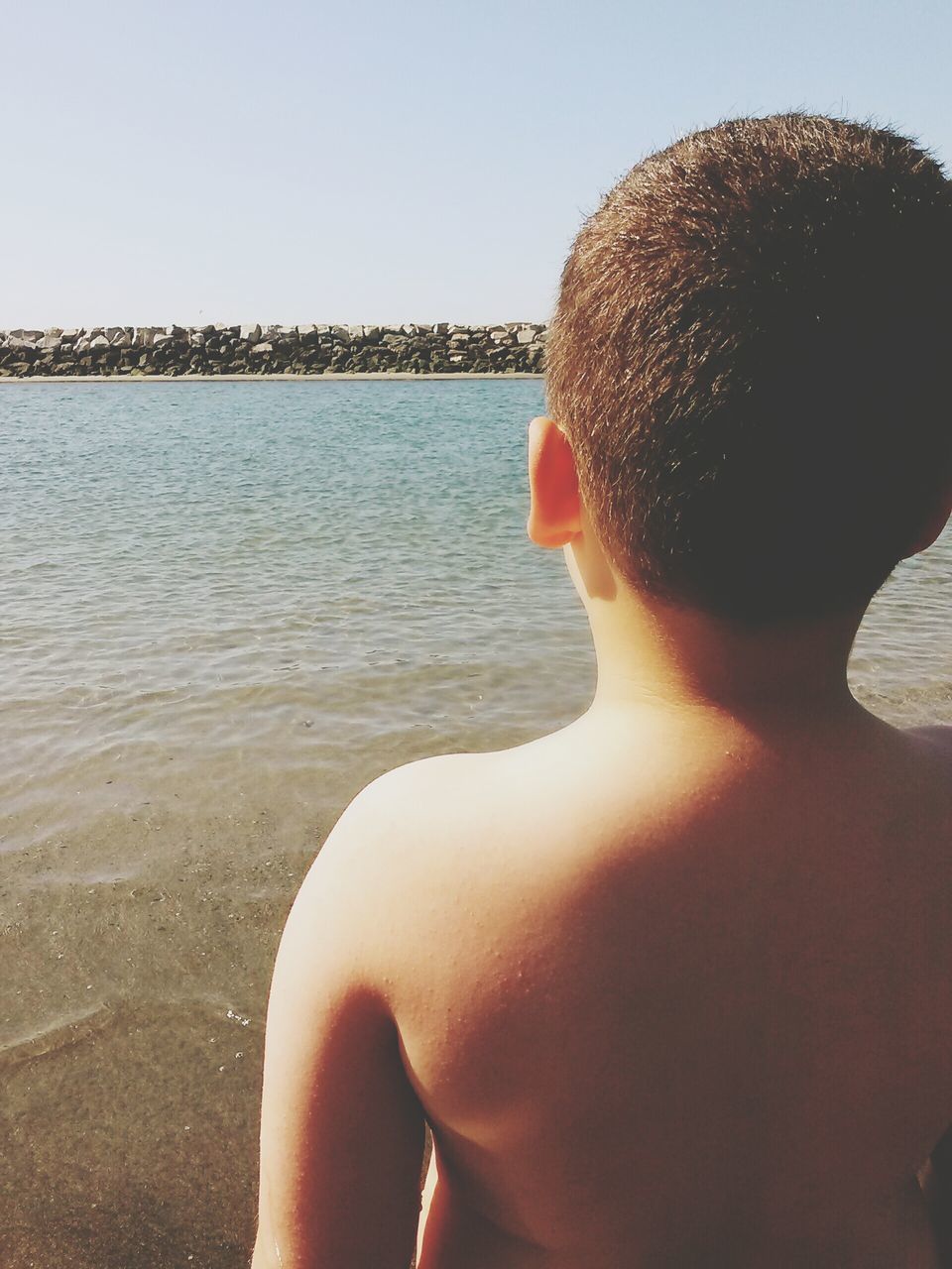 water, sea, beach, lifestyles, leisure activity, shore, clear sky, sky, headshot, horizon over water, vacations, young adult, person, sunglasses, sunlight, standing, shirtless