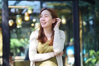 Portrait of young woman standing outdoors