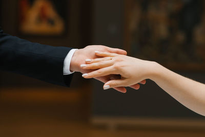 Groom stretches out his hand to the bride