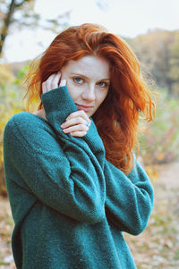 Portrait of a young redhead woman with freckles.