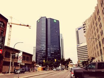 City street and buildings against clear sky