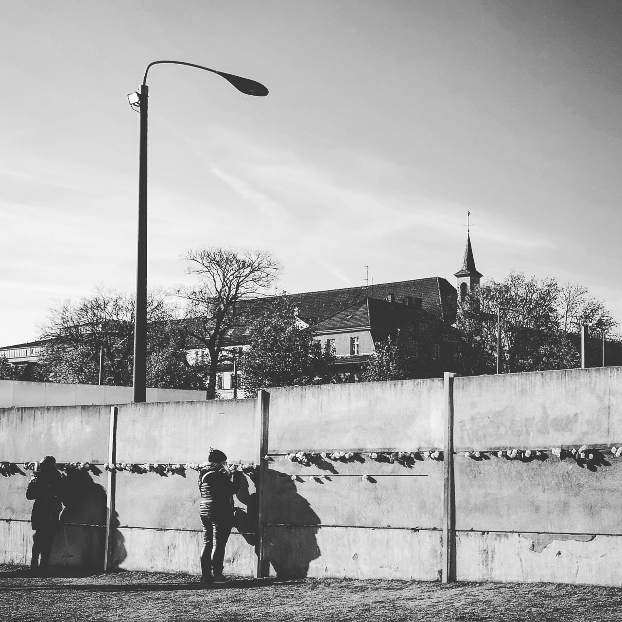 street, architecture, building exterior, built structure, street light, sky, men, real people, city, nature, day, people, lifestyles, lighting equipment, building, outdoors, walking, leisure activity