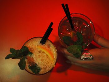 Close-up of drink on table against red background