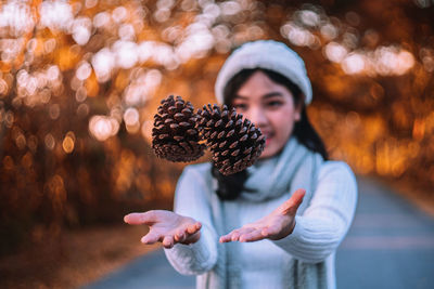 Woman catching pine cones