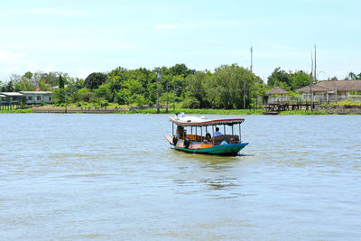 Boat sailing in river against sky