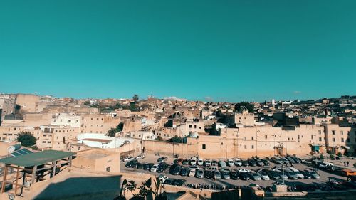 High angle view of townscape against clear blue sky