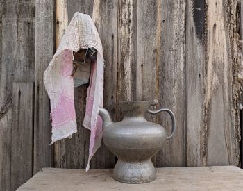 Close-up of figurine on table against wall