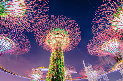 Low angle view of illuminated ferris wheel at night