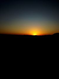 Scenic view of silhouette landscape against clear sky during sunset