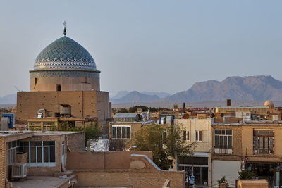 Buildings in city against clear sky