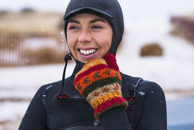 Young woman enjoying winter surfing in snow