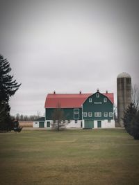 Houses on field against sky
