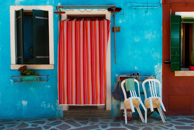 Chairs and tables against building