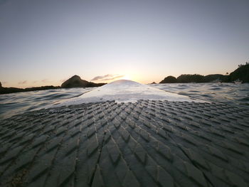 Scenic view of sea against clear sky during sunset