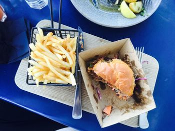 Directly above shot of burger and french fries on restaurant table