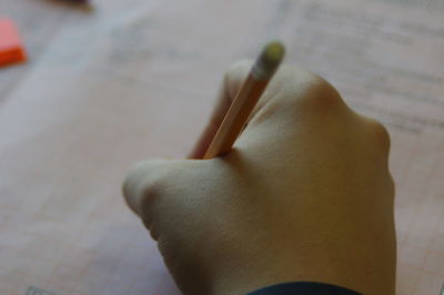 Close-up of hand holding paper