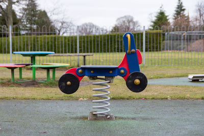 Close-up of multi colored spring ride in park