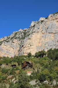 Scenic view of mountains against clear blue sky