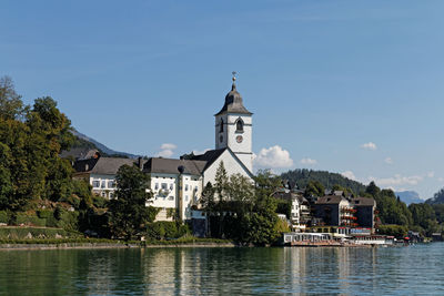 View of buildings and trees against sky