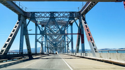 Low angle view of bridge against clear blue sky