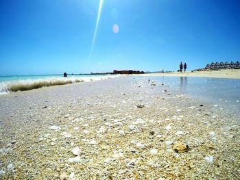 Surface level of beach against clear sky