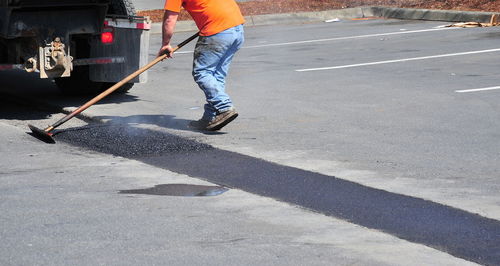 Low section of man working on road