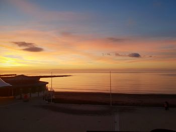 Scenic view of sea against orange sky