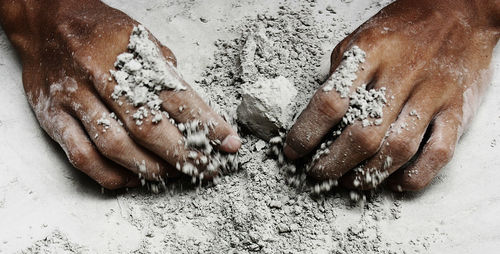 Cropped hands mixing cement