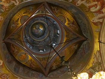 Directly below shot of ornate ceiling in building