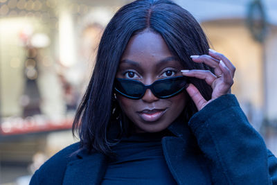 Portrait of young woman wearing sunglasses