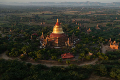 Panoramic view of pagodas in green fields in bagan