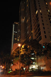 Illuminated city against sky at night